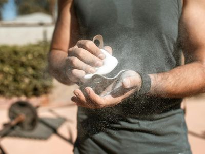 Chalked hands of an athlete preparing for a lift.
