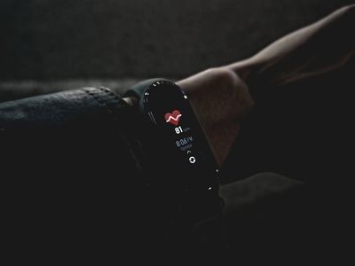 Focus on a heart rate monitor on a man's wrist.